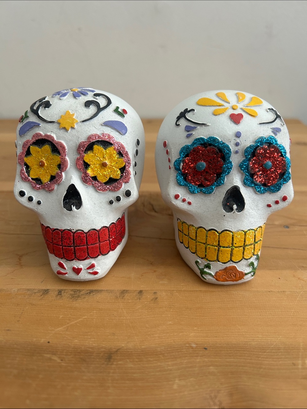 Pair of White Sugar Skull Figurines with Red & Yellow Accents